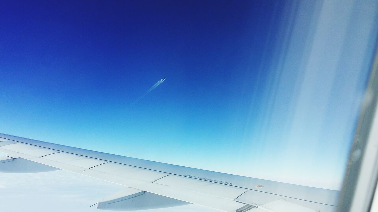 blue, airplane, no people, flying, sky, transportation, air vehicle, low angle view, clear sky, vapor trail, day, outdoors, nature, close-up, airplane wing, air force