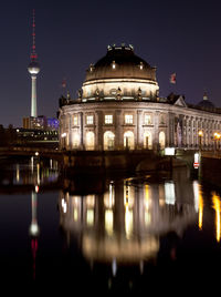 Reflection of buildings in city at night