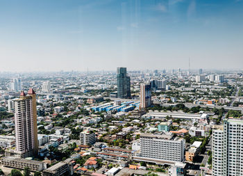 High angle view of modern buildings in city against sky