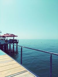 Pier on sea against clear sky