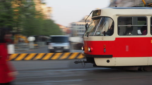 Blurred motion of train on road in city