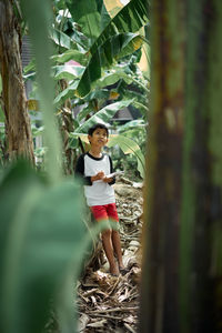 Portrait of young woman standing on land