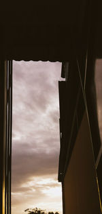 Low angle view of silhouette building against sky