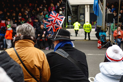 Rear view of people standing on street