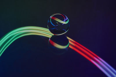 Close-up of light painting against black background