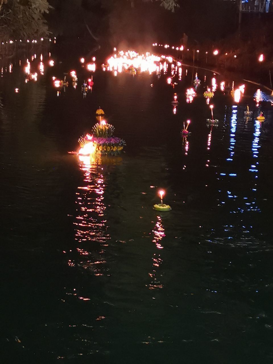 REFLECTION OF ILLUMINATED LIGHTS IN RIVER