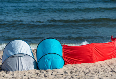 Bbeach screen on the polish beach on a sunny summer day in the background beautiful sea.