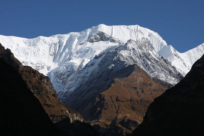 Scenic view of snowcapped mountains against clear sky