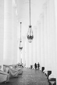 Grand walkways with marble columns surrounding the piazza san pietro in the vatican city