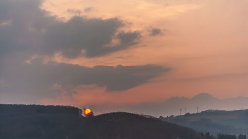 Scenic view of silhouette mountains against sky during sunset