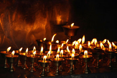 Close-up of lit candles in temple