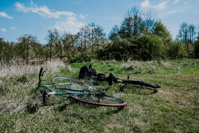 Bicycle on grassy field against sky