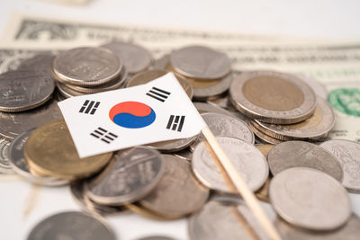 Close-up of coins with flag on table