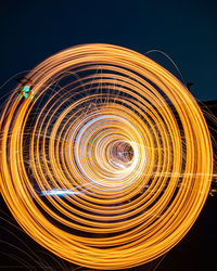 Abstract image of light trails against black background