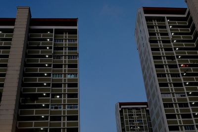 Low angle view of buildings against clear blue sky