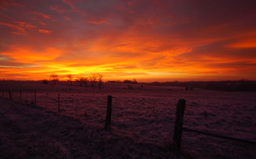 Scenic view of field against sky during sunset