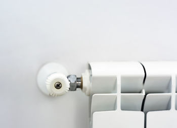 Close-up of camera on white wall