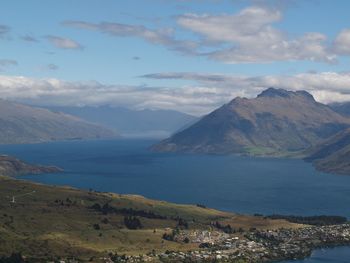 Scenic view of sea and mountains against sky