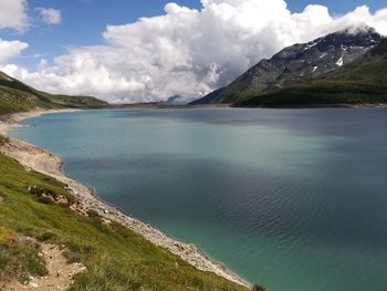 Scenic view of sea and mountains against sky