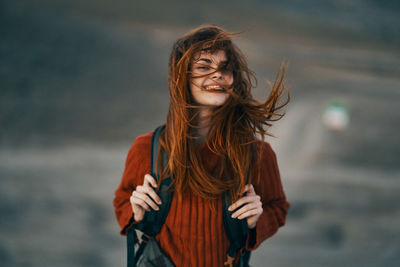 Portrait of a smiling young woman standing outdoors