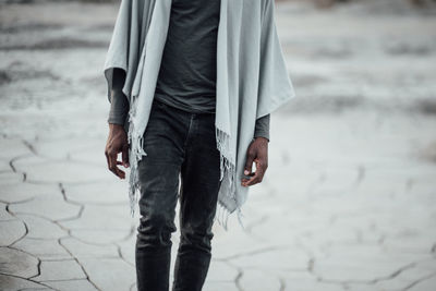 Man holding umbrella at beach