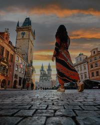 Buildings in city against sky during sunset