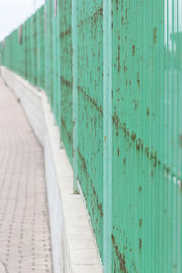 Close-up of footpath against wall