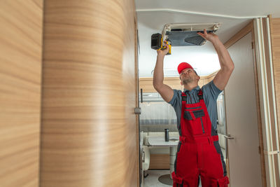 Rear view of man exercising in gym