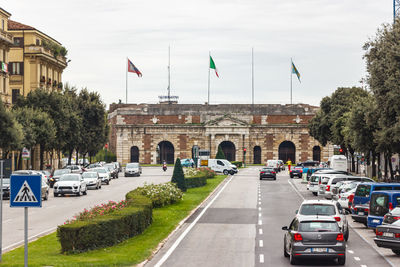 Vehicles on road against buildings in city