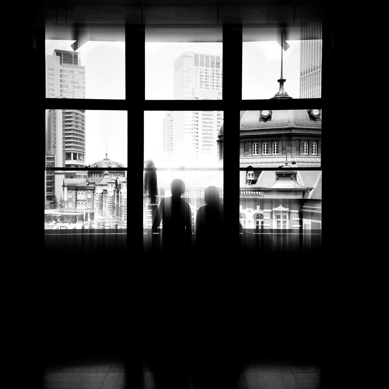 window, indoors, architecture, built structure, glass - material, transparent, silhouette, building exterior, men, looking through window, person, lifestyles, city, standing, rear view, day, building, residential structure