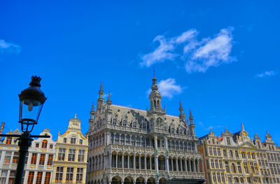 Low angle view of buildings against blue sky