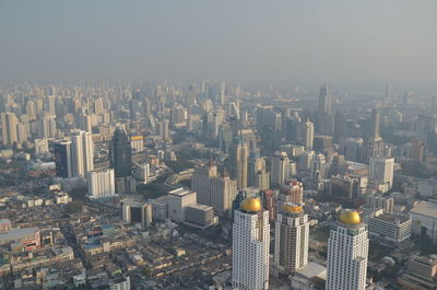 High angle view of modern buildings in city against sky