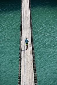 High angle view of man walking on a bridge