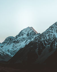 Scenic view of snowcapped mountains against clear sky