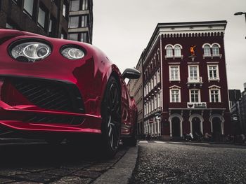 Car on street against buildings in city