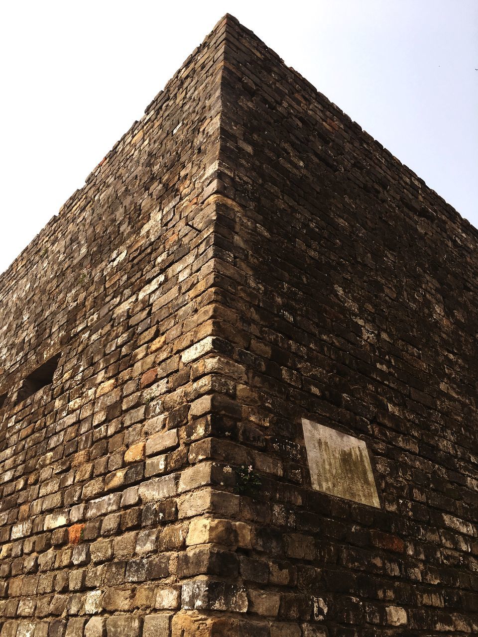 architecture, building exterior, built structure, low angle view, brick wall, clear sky, wall - building feature, stone wall, old, window, sky, history, outdoors, day, building, no people, tower, brick, wall, the past