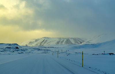 Snow covered road against sky