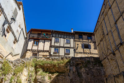 Low angle view of old building against clear blue sky