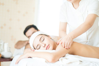 Midsection of woman lying on bed