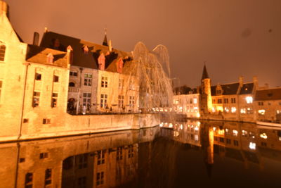 Reflection of illuminated buildings in water at night