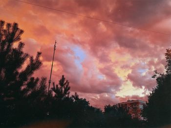 Low angle view of silhouette trees against sky during sunset