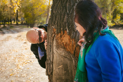 Man with tree trunk