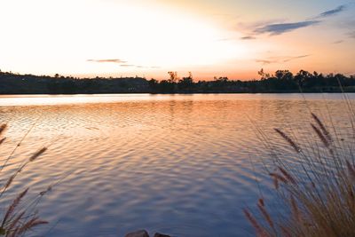 Scenic view of lake against orange sky