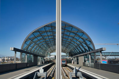 View of railroad tracks against clear blue sky