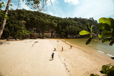 People on beach against sky