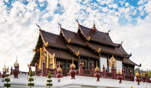 Low angle view of temple against cloudy sky