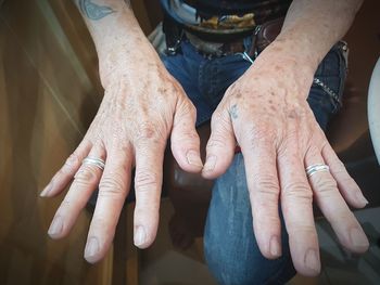 Midsection of man showing finger rings at home