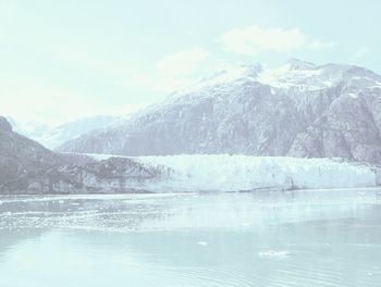 Scenic view of snow covered mountains against sky