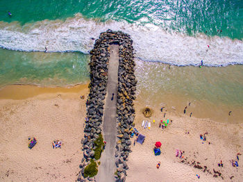 High angle view of people on pier and beach