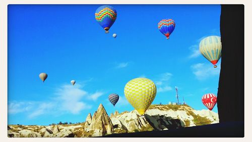 Low angle view of balloons against blue sky